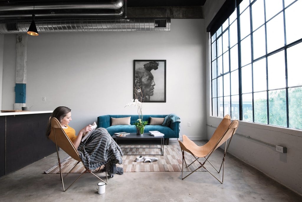 a woman sitting in a chair in a living room